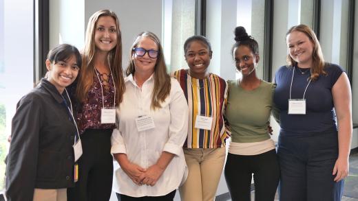 Terri Armstrong smiles with five of her postbaccalaureate fellows