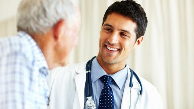 Young male doctor with an older male patient. 